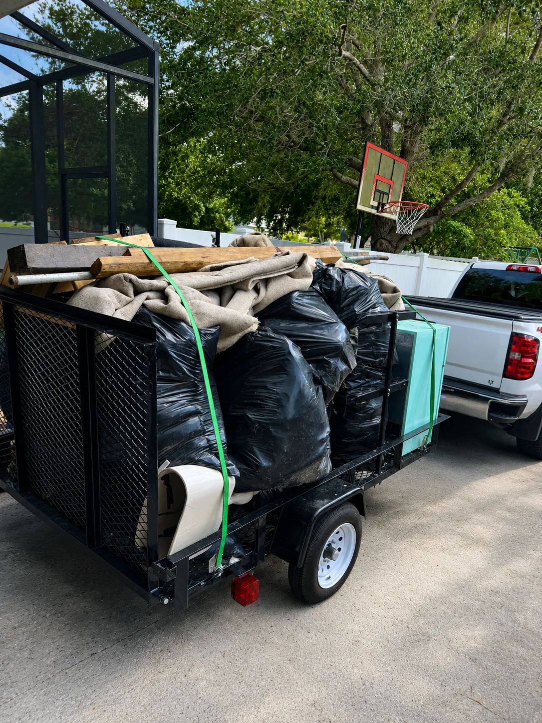 Ancient City Junk Removal trailer loaded with yard and household debris