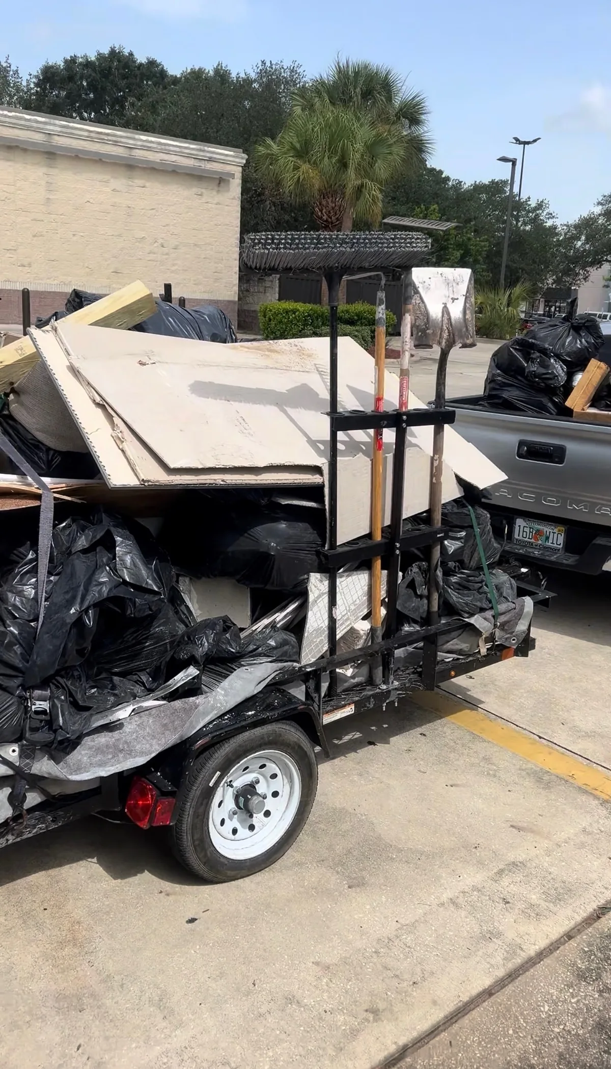 Ancient City Junk Removal trailer loaded with drywall and construction debris